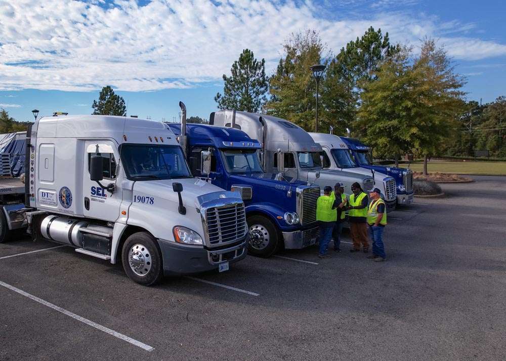 SEL Transportation drivers in front of their trucks